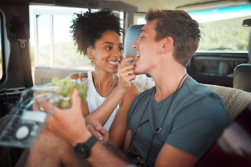 Image showing Road trip, grapes and couple eating in van on travel journey, holiday or countryside date with love, care and diversity, Friends camper people and farm fruit food for healthy lifestyle in a caravan