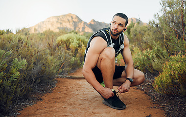Image showing Fitness, nature and man tie shoes before start of marathon training, exercise or health workout in USA Hollywood Hills. Sports, dirt path and runner ready for peace, freedom or wellness cardio run