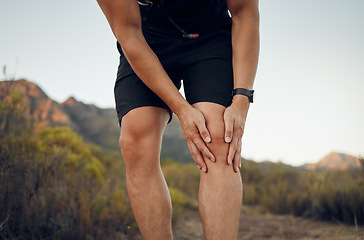 Image showing Man, knee pain and injury in fitness exercise, training and health workout in nature park or countryside hiking trail. Zoom, hands and sports runner with risk emergency and medical leg accident