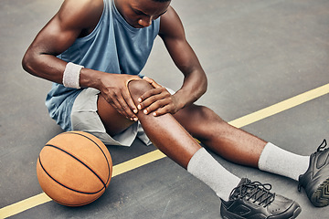 Image showing Fitness, basketball knee injury or pain while on basketball court holding leg in exercise, training or sport workout. Professional athlete, health or sports man with accident in street game or event