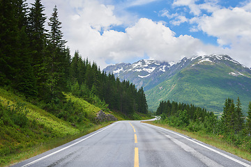 Image showing Road mountain, highway and countryside environment with freedom for travel, summer snow in Alaska and street or adventure. Landscape of calm driveway path in nature for transportation on holiday