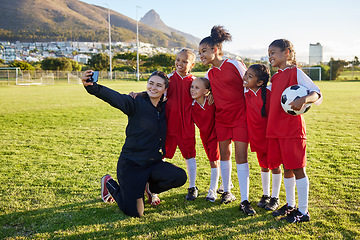 Image showing Soccer, team and coach selfie with phone on a field after training, practice or game at a sports club. Football girl group smile and happy with photo for social media on a sport ground together