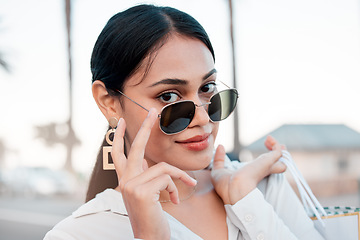 Image showing Face, fashion and woman in sunglasses with shopping bags in city for designer clothing in mall or boutique. Portrait, wealth or rich woman smile or retail customer from Brazil in cool stylish glasses