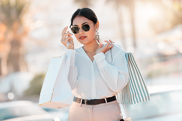 Image showing Shopping, fashion and city woman with bag walk on street road after buying luxury designer clothes on sales discount. Rich, wealth or chic customer travel in Toronto Canada after retail therapy spree