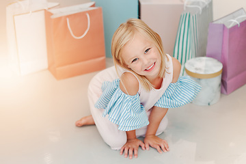 Image showing Birthday, gift or present with girl child portrait for fashion, boutique and luxury lifestyle. Kid on floor with shopping bags, young retail customer for children discount, clothes sale marketing