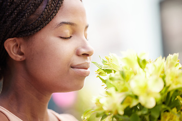 Image showing Black woman, flowers and smelling fragrance happy, satisfied and relax face in spring with blossom. Girl, bouquet and gift smile with scent of petals, leaf and plants in floral design from nature