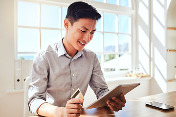 Image showing Business, asian and online shopping man with tablet satisfied with payment using credit card. Happy corporate worker with smile in Hong Kong company enjoying ecommerce break at table in office.