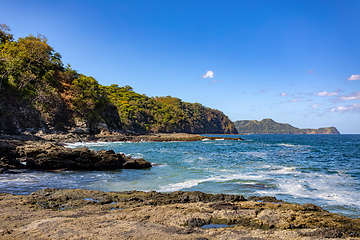 Image showing Playa Ocotal and Pacific ocean waves on rocky shore, El Coco Costa Rica