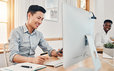 Image showing Credit card, online payment and businessman shopping on mobile app on a phone in an office at work. Asian employee banking with debit card on smartphone, happy with retail and finance on the web