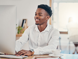 Image showing Computer, typing and black man working in the office, doing research and writing emails. Technology, work and businessman with smile on face in workspace for innovation, internet and startup company