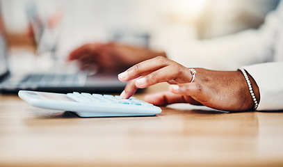 Image showing Accountant doing budget planning, money and finance management and bookkeeping or tax. Black woman using calculator, laptop and financial accounting at her desk in a corporate office closeup.