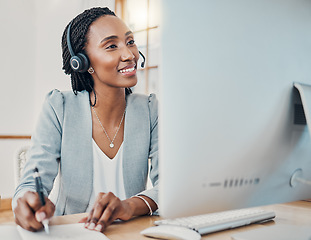 Image showing Headset, call center and black woman use computer working at desk in office or work online from home. Smile, female consultant or happy worker in telemarketing and make meeting notes