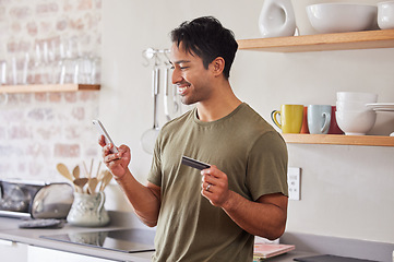 Image showing Credit card, finance and man with smartphone for online shopping in kitchen at home. Indian, make payment with money for e commerce transaction and search the internet for investment.