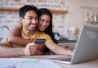 Image showing Laptop, credit card and finance with an accounting couple using a computer for ecommerce in the kitchen of their home. Money, savings and investment with a man and woman making an internet purchase