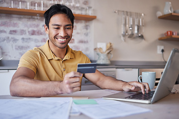 Image showing Finance, laptop and credit card with a man doing accounting or household budget from the kitchen of his home. Ecommerce, savings and investment with a male working on wealth management for the future