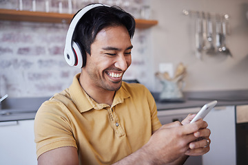 Image showing Phone, music and man on social media laughing at a funny joke on a podcast, network app or video streaming website. Smile, meme and happy Asian person sharing trendy online content to relax at home