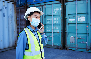 Image showing Covid, phone and supply chain logistics with a woman shipping worker on a call while on a commercial container yard. Freight, cargo and communication with a female courier at work with export storage