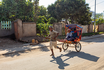 Image showing Traditional rickshaw on the Antsirabe city streets. Rickshaws are a common mode of transport in Madagascar.