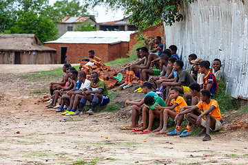 Image showing Soccer fans sitting on the ground and watching a local match between two teams from the village. Bekopaka Madagascar