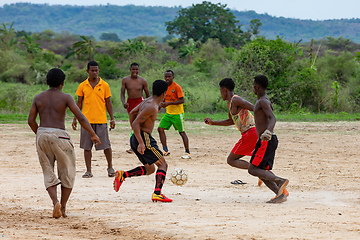 Image showing A group of young men play soccer on a dirt field in Bekopaka, Madagascar