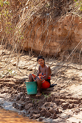 Image showing Rural Life in Belo Sur Tsiribihina, Madagascar An everyday moment of a woman collecting water by the river in Belo Sur Tsiribihina.