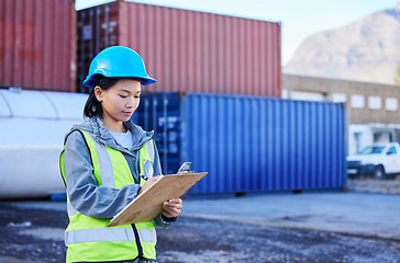 Image showing Logistics, inspection and worker working on shipping of delivery at an outdoor warehouse or port. Asian industrial employee writing notes and inventory while working in the supply chain business