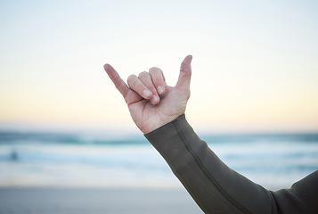 Image showing Shaka, surf and sports with the hand sign of a man on the beach for surfing, fitness or exercise in the morning. Workout, training and health with a male surfer outdoor for wellness or cardio