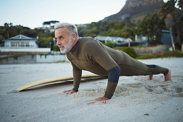 Image showing Senior man, beach and fitness in South Africa of surfer in exercise for morning routine warm up. Elderly male in surfing sports and training pushups getting ready for healthy workout by the ocean