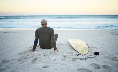 Image showing Beach, back view and old man surfer on holiday vacation in retirement relaxing and chill on ocean sand in Portugal. Surfing, senior and healthy person with surfboard watching waves at sea outdoors