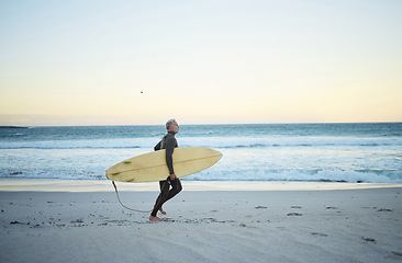 Image showing Beach, water and surf of a man on sand with surfboard walking the ocean coast in the morning outdoors. Male surfer running with longboard in Costa Rica for healthy fitness and travel on vacation