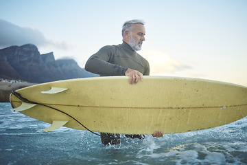 Image showing Surf, board and senior man in ocean for fun, adventure or sports exercise while surfing in Rio de Janeiro Brazil. Surfer lifestyle, freedom and elderly person in the sea for wellness, health or peace