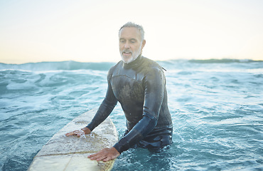 Image showing Surfing, ocean and senior man swimming with board in sea blue waves and morning sky mockup. Sports, fitness and adventure surfer in tropical water for vacation, summer holiday or wellness lifestyle