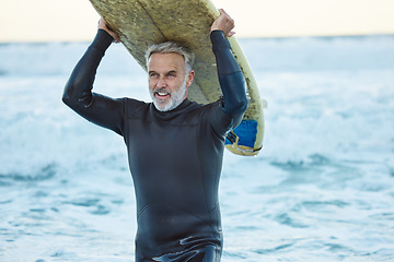 Image showing Beach, board and man surfing the waves in the water on holiday in the Maldives during travel in summer. Mature surfer happy and thinking with smile in ocean on vacation in nature for peace and calm