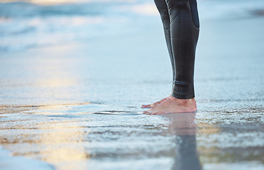 Image showing Surf, water and legs of man on the beach for fun adventure, fitness and exercise workout in Rio de Janeiro Brazil. Sand, wellness peace and feet of surfer with wetsuit for sports surfing in ocean sea