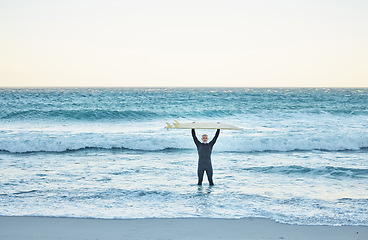 Image showing Senior man, surfboard and ocean surfer, ready to surf Canada sea waves on summer holiday or vacation. Fitness, workout and elderly male in retirement surfing, recreation exercise or water sports.