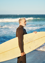 Image showing Senior man, beach and surfboard surfer, ready to surf Australia sea waves on vacation or holiday. Health, fitness and elderly retired male rest after surfing, training or recreation exercise in ocean