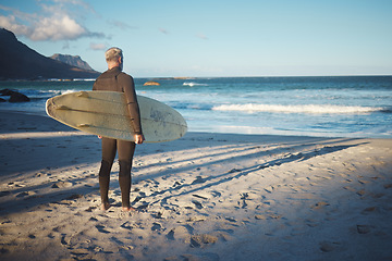 Image showing Surfer, elderly and beach for wellness, fitness and health to surf on adventure in summer. Senior, man and sea in morning with waves by ocean to relax, workout and exercise in water in Australia