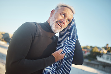 Image showing Surfer, towel and swimming with senior man drying hair after a swim, surf and water sports while on a surfing trip, adventure and summer vacation. Happy male smiling in a wetsuit while on holiday