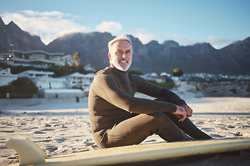 Image showing Surf, sports and sand with a mature man on the beach for surfing, fitness and exercise while on summer holiday. Workout, training and health with a surfer and his surfboard enjoying retirement travel