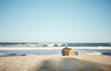 Image showing Surf, sea and sports with a man on the beach for surfing, fitness or training with a horizon view and sky mockup. Workout, exercise and health with a male surfer sitting on sand with his surfboard