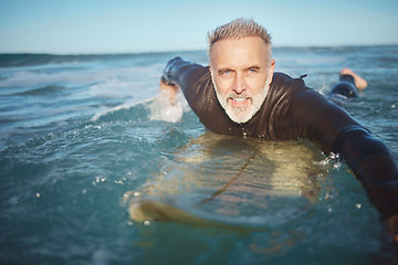 Image showing Water, beach and man surfing waves for adventure during retirement on holiday in ocean in summer. Mature surfer on board in the sea on vacation on an island during travel in Hawaii in nature