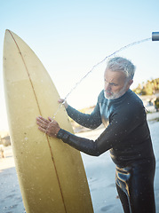 Image showing Old man, beach and surfer cleaning surfboard, surfing in Mexico on summer holiday or vacation. Washing, shower and elderly retired male remove sand on board after surf or training exercise in ocean.