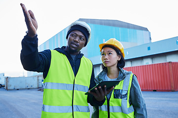 Image showing Logistics, black man and Asian woman with tablet, shipping and conversation for container planning, cargo and supply chain delivery at shipyard. Employees, strategy .and discuss import and export.