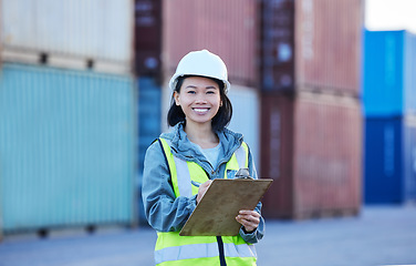 Image showing Woman with clipboard, shipping and logistics check of stock at work site. Asian worker in transportation industry, smile in portrait with container in background and safety inspection of product.