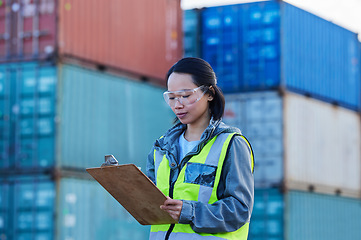 Image showing Logistics, Asian woman and check containers, export and import for supply chain at shipyard with clipboard. Female supervisor, planning or confirm storage cargo shipping, strategy and global business