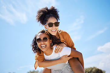 Image showing Summer, friends and freedom with women and piggy back against the blue sky for hug, lifestyle and happy on Puerto rico holiday. Youth, crazy and friend with girl on vacation with glasses and a smile