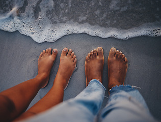 Image showing Couple feet, beach sand and water at ocean waves, nature and summer travel for vacation, honeymoon date and tropical holiday outdoors. Closeup above man, woman and foot toes at sea, relax and freedom