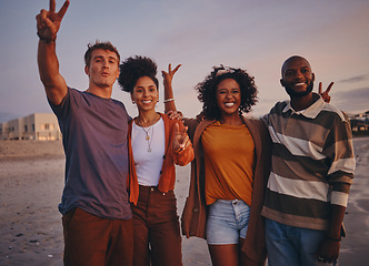 Image showing Diversity, friends and on beach at sunset show peace, sign or relax together on holiday and vacation. Happy group, smile or on seaside getaway, trip or weekend break have fun, good time or travelling