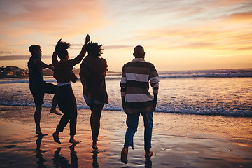 Image showing Silhouette, friends and at the beach or sea relax, happy and have fun with sunset view on vacation together. Group, men and women or couples travel, enjoy seaside and ocean holiday weekend bare feet.