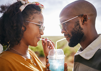 Image showing Love, share and drink with straw and couple in nature for travel, countryside and sunset date on Madrid vacation. Happy, summer and romance with black man and woman drinking together on holiday